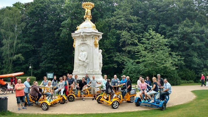 Happy business customers from Germany on four of our FunBikes / Teambikes / ConferenceBikes inside the "Tiergarten" park in the center of Berlin.