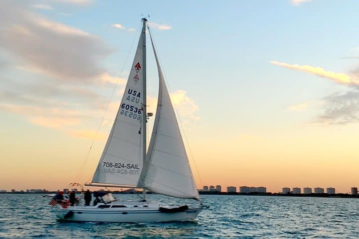 Our sailboat, Bernard, sailing at sunset.