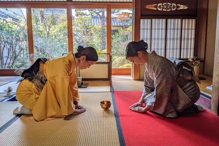 Serving tea to a guest at Garden Teahouse.