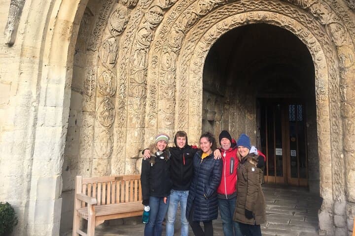 At the wonderfully ornate Norman entrance to Malmesbury Abbey